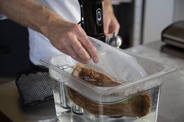 Place the vacuum-sealed veal into the sous vide water bath 