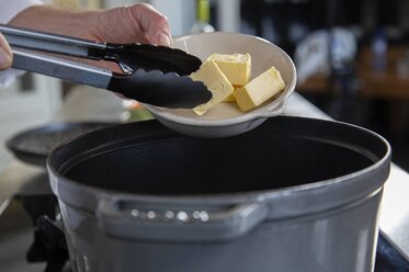 Put the butter into the casserole dish